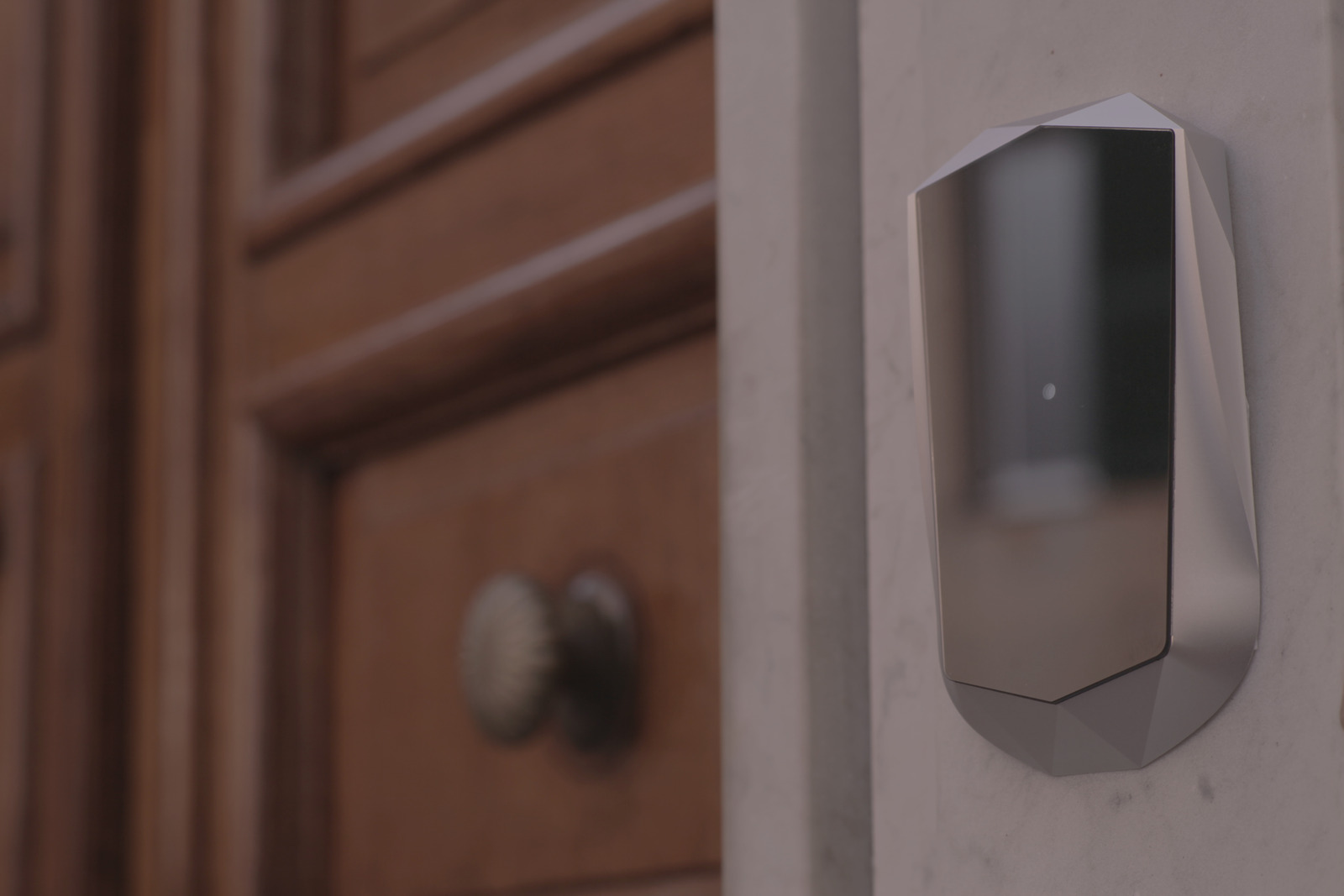 A 1aim LightAccess Pro Access Module mounted on a door frame beside a wooden door.