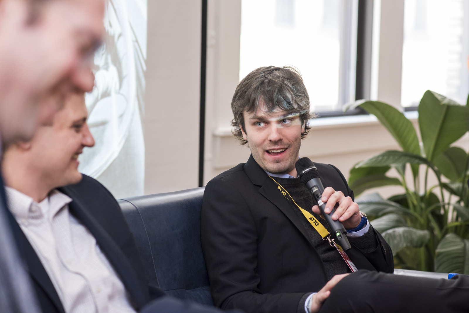 Torben Friehe speaking on a panel at a DLD conference.