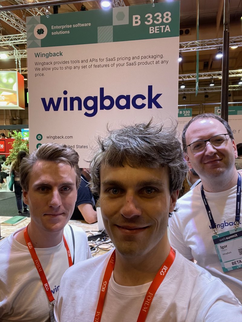 Three members of the Wingback team in front of the Wingback stand at Web Summit.
